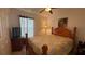 Bedroom with a ceiling fan, window and a patterned bedspread at 2646 Quarterdeck Ct, Kissimmee, FL 34743