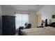 Bedroom featuring a queen-sized bed, a large armoire, and a comfy armchair at 2646 Quarterdeck Ct, Kissimmee, FL 34743