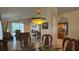 Open concept dining room with wicker table and chairs leading into the living room at 2646 Quarterdeck Ct, Kissimmee, FL 34743