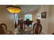 Dining room boasts vaulted ceiling, decorative hanging light, and wicker chairs and table at 2646 Quarterdeck Ct, Kissimmee, FL 34743