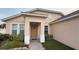 Inviting front entrance with decorative door, manicured shrubbery, and a brick walkway at 2646 Quarterdeck Ct, Kissimmee, FL 34743