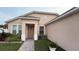 Inviting front entrance with decorative door, manicured shrubbery, and a brick walkway at 2646 Quarterdeck Ct, Kissimmee, FL 34743