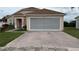 Charming one-story home featuring a screened garage and brick-paved driveway at 2646 Quarterdeck Ct, Kissimmee, FL 34743
