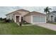 Charming one-story home featuring a screened garage and brick-paved driveway at 2646 Quarterdeck Ct, Kissimmee, FL 34743