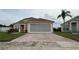 Charming one-story home featuring a screened garage and brick-paved driveway at 2646 Quarterdeck Ct, Kissimmee, FL 34743