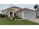 Charming one-story home featuring a screened garage and brick-paved driveway at 2646 Quarterdeck Ct, Kissimmee, FL 34743
