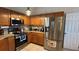 Well-appointed kitchen with stainless steel appliances, granite countertops, and wood cabinets at 2646 Quarterdeck Ct, Kissimmee, FL 34743