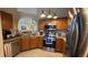 Well-appointed kitchen with stainless steel appliances, granite countertops, and wood cabinets at 2646 Quarterdeck Ct, Kissimmee, FL 34743