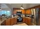 Well-appointed kitchen with stainless steel appliances, granite countertops, and wood cabinets at 2646 Quarterdeck Ct, Kissimmee, FL 34743