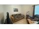 Inviting living room with a futon, TV, and ample seating at 2646 Quarterdeck Ct, Kissimmee, FL 34743