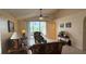 Bright living room with vaulted ceiling, ceiling fan, and sliding glass doors to the outdoors at 2646 Quarterdeck Ct, Kissimmee, FL 34743