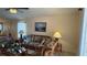 Bright living room with wicker furniture, neutral walls, and tile flooring at 2646 Quarterdeck Ct, Kissimmee, FL 34743