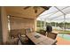 Outdoor patio features covered area, pool with a scenic water view, table and chairs at 2646 Quarterdeck Ct, Kissimmee, FL 34743