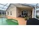 A screened-in pool with adjacent patio and dining table and scenic lake views at 2646 Quarterdeck Ct, Kissimmee, FL 34743
