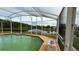 Screened-in pool with scenic lake views and adjacent patio at 2646 Quarterdeck Ct, Kissimmee, FL 34743