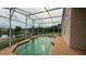 Screened-in pool with adjacent lake views at 2646 Quarterdeck Ct, Kissimmee, FL 34743