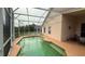 Screened-in pool with adjacent patio and scenic lake views at 2646 Quarterdeck Ct, Kissimmee, FL 34743