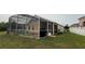 View of the screened in pool with attached home and green lawn at 2646 Quarterdeck Ct, Kissimmee, FL 34743