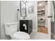 Stylish bathroom with modern vanity, toilet, and open door to a storage nook at 2700 Palm Isle Way, Orlando, FL 32829