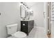 Stylish bathroom with modern vanities and fixtures; features grey tile flooring and a comfort height toilet at 2700 Palm Isle Way, Orlando, FL 32829