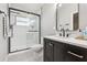 Updated bathroom with a sleek glass-enclosed shower and a modern vanity with black fixtures at 2700 Palm Isle Way, Orlando, FL 32829