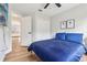 Bright bedroom with a queen-sized bed, wood floors, closet, and a door to living area at 2700 Palm Isle Way, Orlando, FL 32829