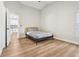 Bedroom featuring wood flooring, neutral paint, a queen bed and views of an adjacent living area at 2700 Palm Isle Way, Orlando, FL 32829