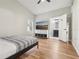 Light-filled bedroom with a wood floor, walk-in closet, and an adjacent bathroom with modern fixtures at 2700 Palm Isle Way, Orlando, FL 32829