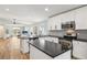 Modern kitchen with white cabinets, black countertops, and stainless steel appliances at 2700 Palm Isle Way, Orlando, FL 32829