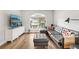 Bright living room with a gray sectional sofa, ottoman, large window, and entertainment center at 2700 Palm Isle Way, Orlando, FL 32829