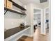 Storage nook with black shelving and wood floor with access to bedroom and bathroom at 2700 Palm Isle Way, Orlando, FL 32829
