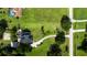 Aerial image of property and surrounding acreage, featuring a long driveway and ample green space at 2851 Granada Blvd, Kissimmee, FL 34746