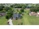 Aerial view of a home with a large yard, a fenced-in area, and a private pond nearby at 2851 Granada Blvd, Kissimmee, FL 34746