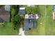 Overhead view featuring a well-maintained property, including a pool, landscaped areas, and ample greenery at 2851 Granada Blvd, Kissimmee, FL 34746