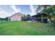 Beautiful backyard with a screened-in lanai, a gazebo, and lush green lawn perfect for outdoor living at 2851 Granada Blvd, Kissimmee, FL 34746
