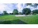 Spacious backyard with a basketball court, a playground, and ample green space for outdoor activities and enjoyment at 2851 Granada Blvd, Kissimmee, FL 34746