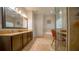 Well-lit bathroom with double vanity, soaking tub, and glass-enclosed shower and vanity area at 2851 Granada Blvd, Kissimmee, FL 34746
