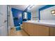 Stylish blue bathroom with double vanity, shower, and modern fixtures at 2851 Granada Blvd, Kissimmee, FL 34746