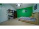 Bright bedroom featuring a bed, dresser, and colorful accent wall at 2851 Granada Blvd, Kissimmee, FL 34746