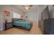 Bedroom with tile flooring, ceiling fan, queen size bed, and modern entertainment center at 2851 Granada Blvd, Kissimmee, FL 34746