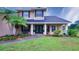 Charming two-story home with well-manicured landscaping, lush greenery, and inviting front entrance at 2851 Granada Blvd, Kissimmee, FL 34746