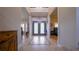 Elegant foyer with tile flooring, decorative chandelier, and double door entry at 2851 Granada Blvd, Kissimmee, FL 34746