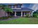Inviting front entrance showcases meticulously landscaped yard and charming architecture at 2851 Granada Blvd, Kissimmee, FL 34746