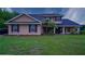 Charming two-story home featuring manicured lawn and a welcoming front porch at 2851 Granada Blvd, Kissimmee, FL 34746