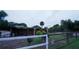 View of a fenced enclosure housing three ostriches with a sheltered feeding area and a grassy outdoor space at 2851 Granada Blvd, Kissimmee, FL 34746