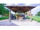 Inviting outdoor bar area under a rustic wooden gazebo, featuring a grill and seating for entertaining at 2851 Granada Blvd, Kissimmee, FL 34746