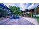 Outdoor patio area with screened-in pool, bar, grill, and ample seating, perfect for entertaining at 2851 Granada Blvd, Kissimmee, FL 34746