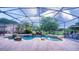 Relaxing pool area featuring a hammock, rock waterfall, and ample patio space at 2851 Granada Blvd, Kissimmee, FL 34746