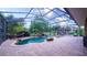 Relaxing pool area featuring a hammock, rock waterfall, and ample patio space at 2851 Granada Blvd, Kissimmee, FL 34746