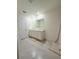 Bathroom featuring double sinks, white cabinets, tiled flooring and a large mirror at 2915 Turnstone, St Cloud, FL 34773